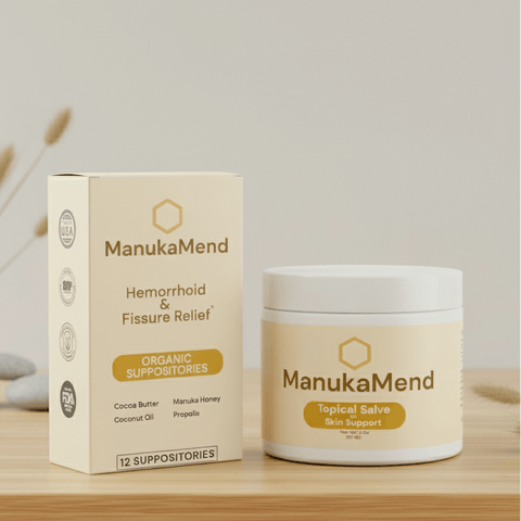 ManukaMend suppository box and jar on a wooden surface with a neutral background